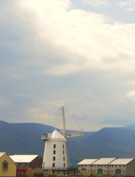 Scenic view of River Island Hotel with family exploring, mountains in background, sunny day.