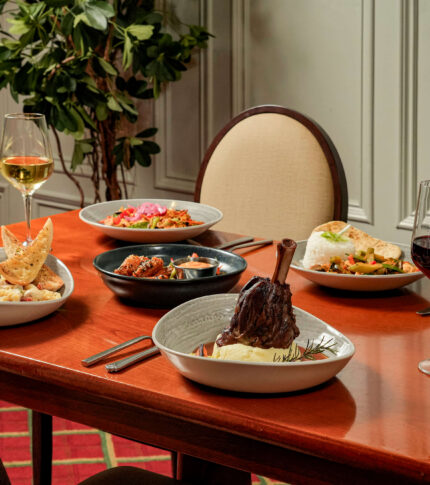 Elegant dining setup at River Island Hotel with delicious dishes and wine.