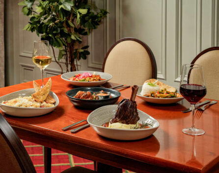 Elegant dining setup at River Island Hotel with delicious dishes and wine.