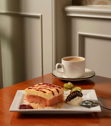 A cosy café table with dessert and coffee at River Island Hotel.
