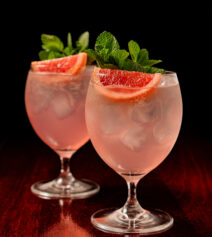Refreshing gin cocktails garnished with grapefruit and mint.