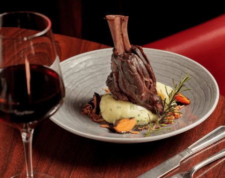 Elegant lamb shank dish with red wine at River Island Hotel restaurant.
