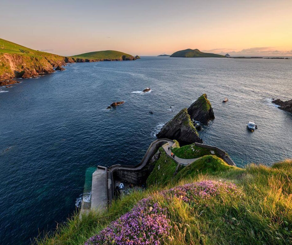 Scenic coastal view near River Island Hotel with serene sunset and distant hills.