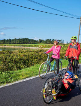 A family cycling along a scenic coastal path near River Island Hotel, Kerry.