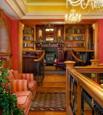 Cosy hotel lounge with Christmas decor and plush seating, perfect for family relaxation.