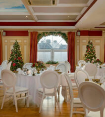 Festive dining area with Christmas trees in River Island Hotel, Kerry.