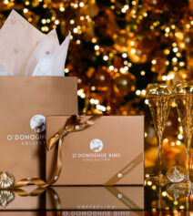 Festive gift boxes and candles in front of a Christmas tree at River Island Hotel