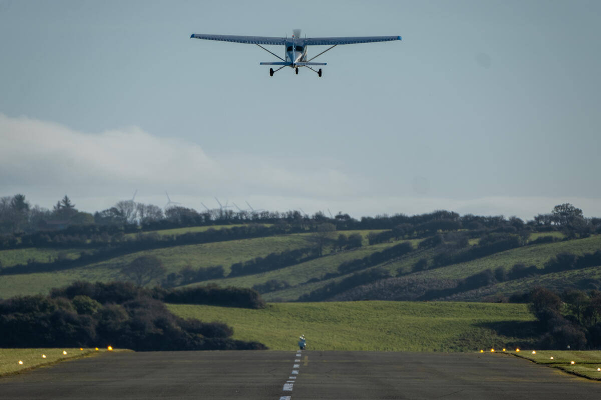 Small plane takes off over lush Kerry countryside near River Island Hotel.