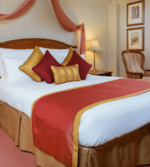 Cosy hotel room with a large bed and vibrant decor at River Island Hotel, Kerry.