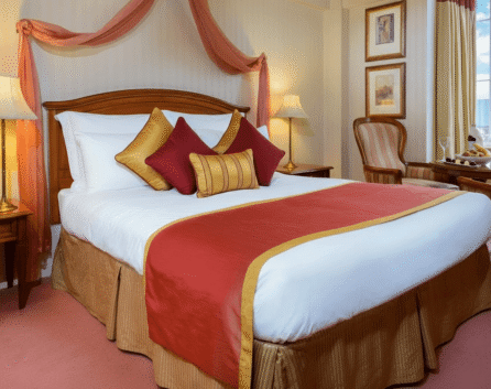 Cosy hotel room with a large bed and vibrant decor at River Island Hotel, Kerry.