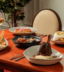 Elegant dining with gourmet dishes and wine at River Island Hotel restaurant.