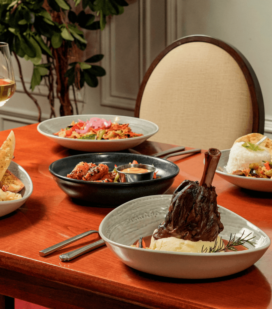 Elegant dining with gourmet dishes and wine at River Island Hotel restaurant.
