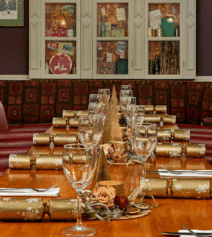 Elegant dining setup with festive crackers at River Island Hotel in Kerry.