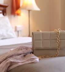 Elegant room at River Island Hotel with a stylish handbag on the bed.