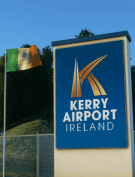 Kerry Airport sign near River Island Hotel in lush, scenic setting.