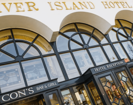 Family outside River Island Hotel entrance, enjoying bright day in Castleisland.