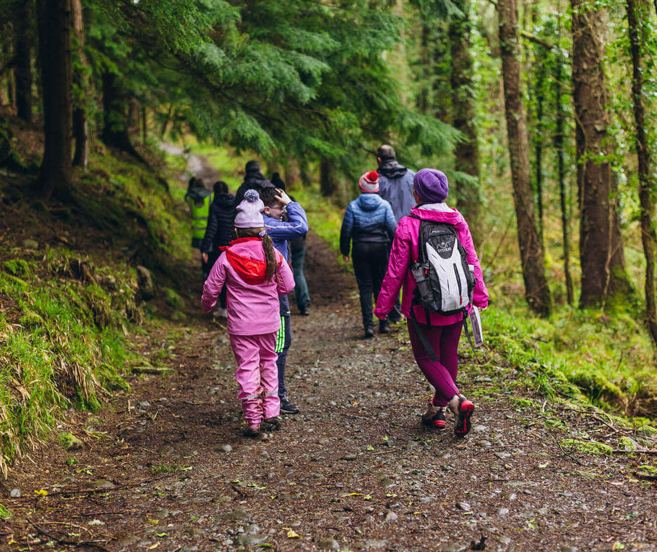Family walking through serene forest trail near River Island Hotel, Kerry.