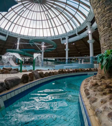 Family enjoying indoor pool with water slides at River Island Hotel, Kerry.