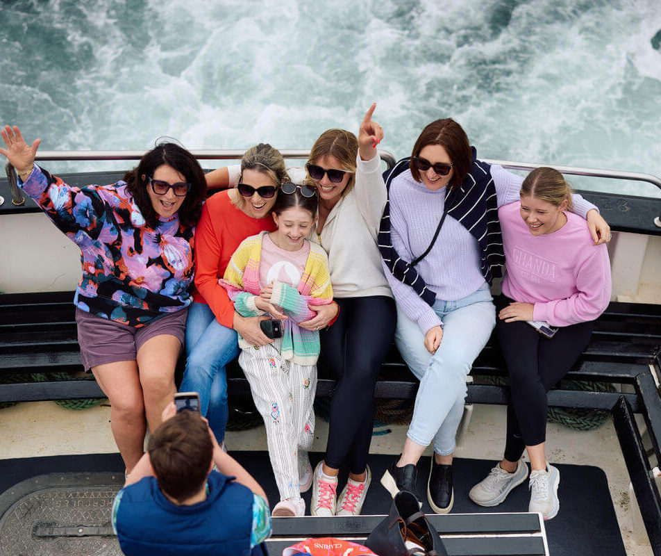 Group enjoying a boat tour near Kerry, capturing joyful moments together.