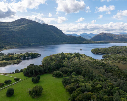 Family by serene lakeside in scenic Kerry, ideal for exploring Ring of Kerry.