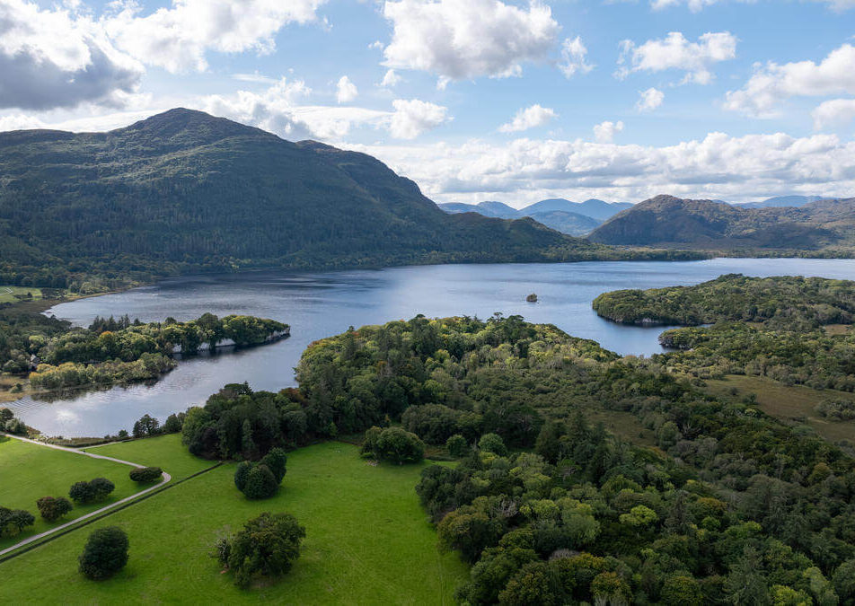 Family by serene lakeside in scenic Kerry, ideal for exploring Ring of Kerry.