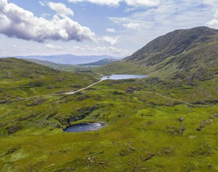 Scenic view of lush green hills and lakes near River Island Hotel, perfect for family excursions.