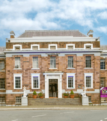 Family entering River Island Hotel in Kerry, set against a bright, clear sky.