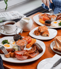 Family enjoying hearty breakfast at River Island Hotel, with traditional Irish dishes and tea.