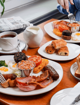 Family enjoying hearty breakfast at River Island Hotel, with traditional Irish dishes and tea.