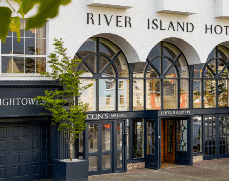 Elegant facade of River Island Hotel with welcoming entrance.