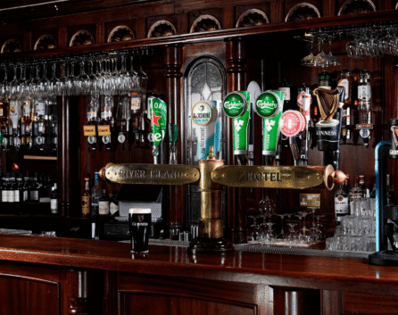Cosy pub area in River Island Hotel with family enjoying drinks and warm wooden decor.