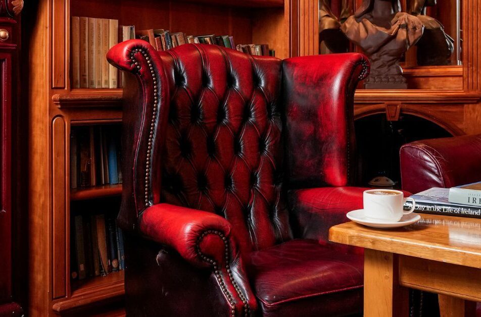 Cosy library corner with red leather armchair and coffee at River Island Hotel.